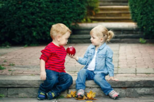 Empathetic child gives an apple